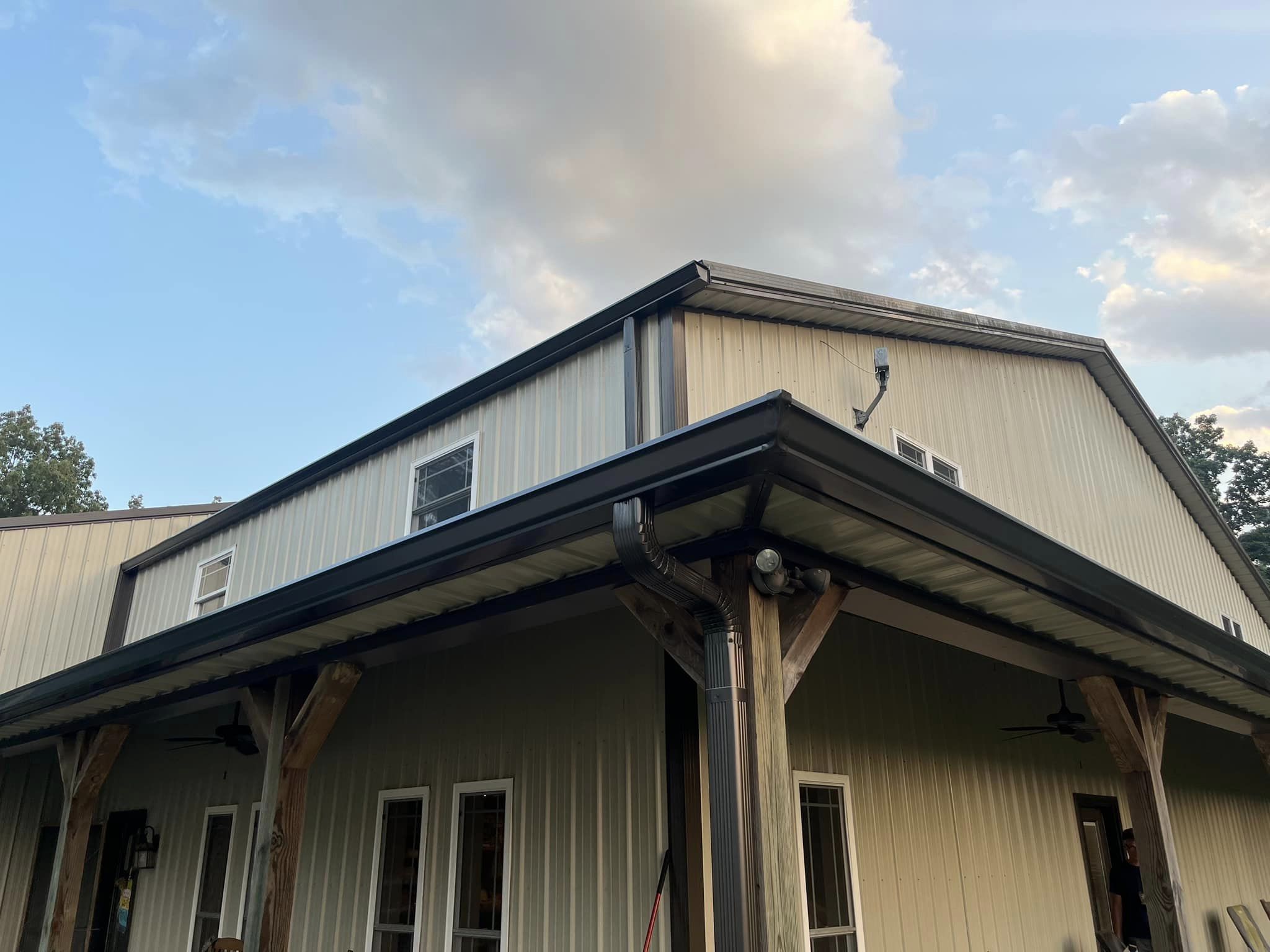 A large white house with a metal roof