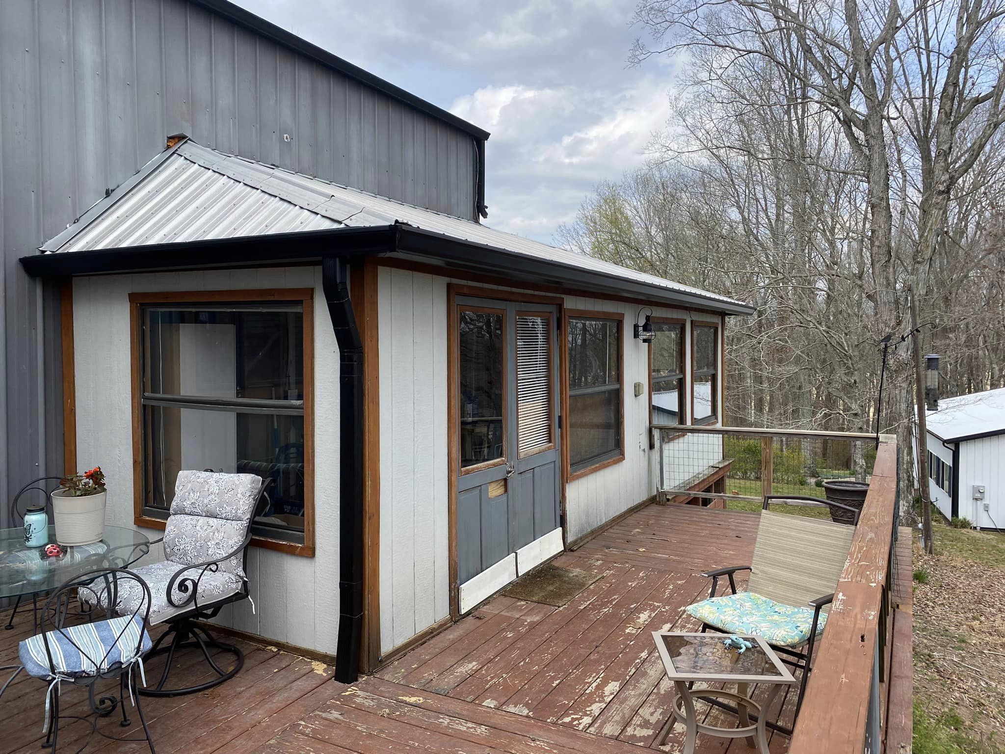 A deck with chairs and a table on it