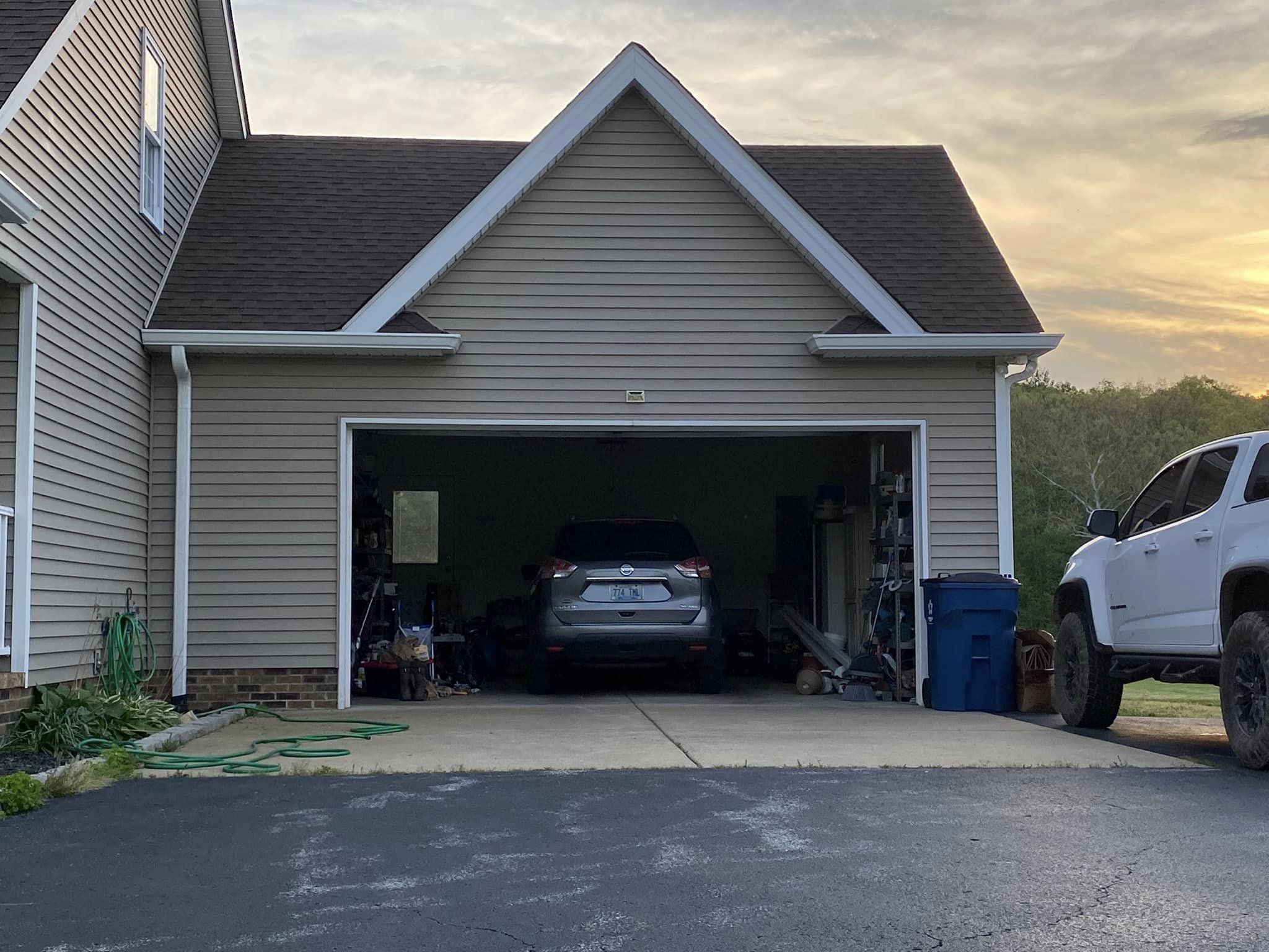 A white truck parked in front of a garage