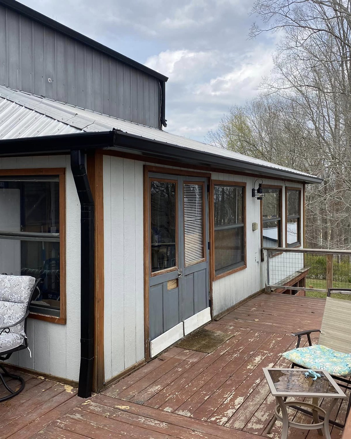 Black seamless gutter and downspout installed by Ridgeline on a Kentucky cabin