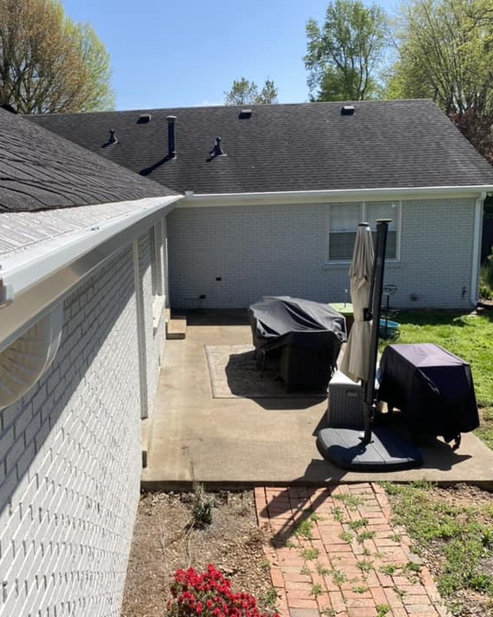 Gutter guard screening fitted over a clean white gutter and downspout in Bowling Green, KY